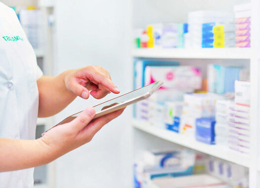 Image of pharmacy worker on ipad